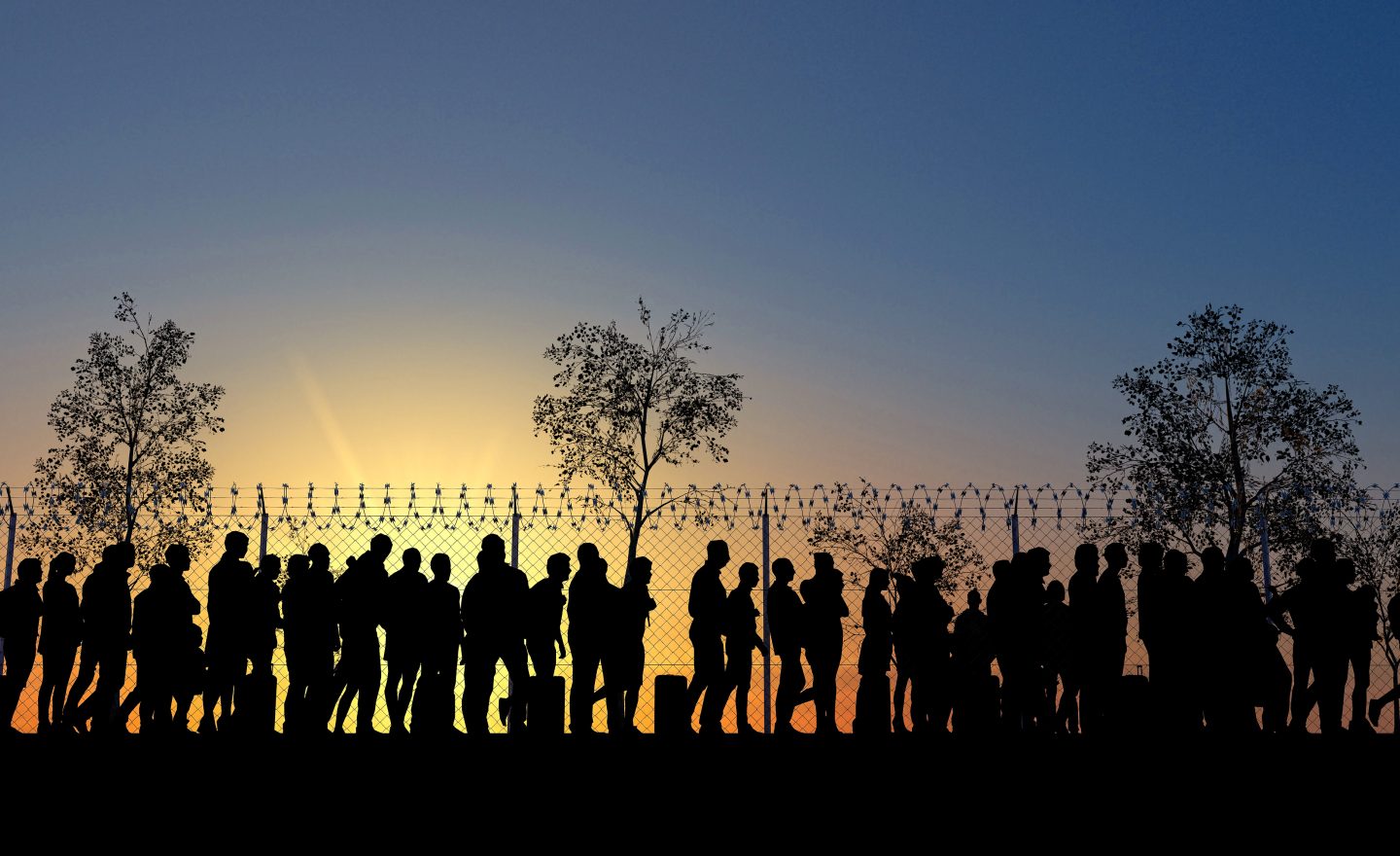 Column of migrants near the state borders. Fence and barbed wire. Surveillance, supervised. Refugees and immigrants
